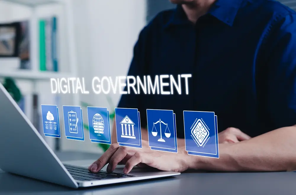 Persona utilizando un ordenador portátil para realizar un trámite digital oficial ante la administración pública.